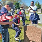Acushnet Cub Scouts help place flags on veterans’ graves